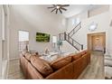 Bright living room with a stylish staircase, modern decor, and ample natural light at 23010 E Pummelos Rd, Queen Creek, AZ 85142