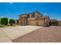 Spacious home boasts desert landscaping, a three-car garage, and stone architectural details at 26080 N 73Rd Ln, Peoria, AZ 85383