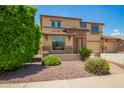 Attractive two-story home with stone accents and a manicured front yard landscaping at 26080 N 73Rd Ln, Peoria, AZ 85383