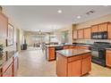 Spacious open-concept kitchen with stainless steel appliances, an island, and plenty of cabinets at 36199 W Prado St, Maricopa, AZ 85138