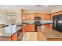 Modern kitchen with black appliances, granite countertops, and a breakfast bar at 36199 W Prado St, Maricopa, AZ 85138
