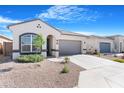Charming single-story home with a two-car garage, landscaped front yard, and neutral color palette at 40816 W Sunland Dr, Maricopa, AZ 85138
