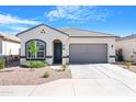 Charming single-story home with a two-car garage, landscaped front yard, and neutral color palette at 40816 W Sunland Dr, Maricopa, AZ 85138