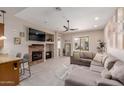 Bright living room features a stone fireplace, comfortable seating, and sliding glass doors to the patio at 4241 N Pebblecreek Pkwy # 7, Goodyear, AZ 85395