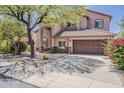 Lovely two-story home with attractive landscaping, mature shade tree and a two-car garage at 4293 S Columbine Way, Gold Canyon, AZ 85118