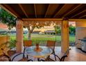Relaxing covered patio with outdoor seating and views of the surrounding green space at 446 S 77Th St, Mesa, AZ 85208