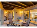 Inviting outdoor patio featuring a table, chairs, and access to the interior at 446 S 77Th St, Mesa, AZ 85208