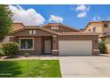 Charming single-story home featuring a well-maintained lawn and a classic, Southwestern-style facade with tile roof at 45309 W Gavilan Dr, Maricopa, AZ 85139