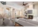 Open-concept living area with fireplace, TV, and modern decor, creating a seamless flow and inviting atmosphere at 6438 E Claire Dr, Scottsdale, AZ 85254