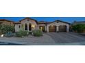 Charming home with a well-manicured front yard and a two-car garage with lovely desert landscaping at 7841 E Stonecliff Cir, Mesa, AZ 85207