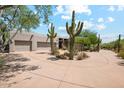 Desert landscaping and native cacti accentuate the home's exterior elevation at 10040 E Happy Valley Rd # 243, Scottsdale, AZ 85255