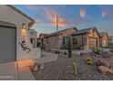 A desert landscaped home featuring cacti, decorative lighting, and inviting pathway to the front door at 10775 E Peralta Canyon Dr, Gold Canyon, AZ 85118