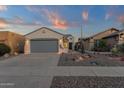Attractive single-Gathering home with desert landscaping, a gray garage door, and a decorative entrance at 10775 E Peralta Canyon Dr, Gold Canyon, AZ 85118