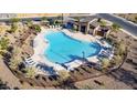 Aerial view of a community pool with lounge chairs, shade structures, and well-maintained landscaping at 10905 E Texas Ave, Mesa, AZ 85212