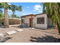 Cozy house showcasing a red door, modern landscaping, and quaint front porch at 1117 W Glenrosa Ave, Phoenix, AZ 85013