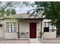 Quaint home featuring a red door, minimalist landscaping, and an inviting facade at 1117 W Glenrosa Ave, Phoenix, AZ 85013