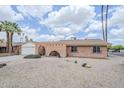 Inviting single-story home with brick facade, desert landscaping, and an attached garage at 11631 N 30Th St, Phoenix, AZ 85028