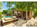 Luxurious backyard with a covered patio, a hot tub, and a sparkling swimming pool at 1268 N Pine St, Gilbert, AZ 85233