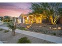 Attractive home exterior with desert landscaping, stone accents, and ample street view under colorful skies at 1337 E Paseo Way, Phoenix, AZ 85042
