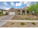 Inviting home exterior showcasing desert landscaping, a paver driveway, and a modern facade at 1337 E Paseo Way, Phoenix, AZ 85042