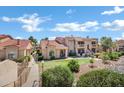 Well-maintained condo exterior with tile roof, desert landscaping, and mini-golf putting green at 16357 E Arrow Dr # 115, Fountain Hills, AZ 85268