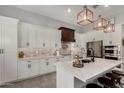 Bright, modern kitchen with white cabinetry, stainless steel appliances, and a stylish island with seating at 1884 E Stephens Dr, Tempe, AZ 85283