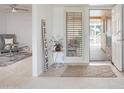 Inviting entryway with tiled floors, a 'WELCOME' sign and a view into the living room at 19030 N Signal Butte Cir, Sun City, AZ 85373