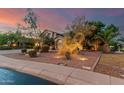 Lovely home with attractive landscaping, exterior lighting, and mature trees, creating an inviting curb appeal at 194 E Canyon Creek Dr, Gilbert, AZ 85295