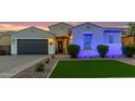 Charming single-story home featuring a well-maintained lawn, desert landscaping and a two car garage at 2618 E Stacey Rd, Gilbert, AZ 85298