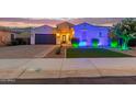 Beautiful single-story home featuring a well-maintained lawn, desert landscaping, and a two car garage at 2618 E Stacey Rd, Gilbert, AZ 85298