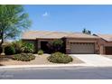 Charming single-story home featuring a well-maintained lawn, desert landscaping, and a two-car garage at 2894 N Paisley Ave, Casa Grande, AZ 85122