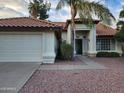 Inviting home showcasing a tiled roof, desert landscaping, and a welcoming front entrance at 4534 E Villa Maria Dr, Phoenix, AZ 85032