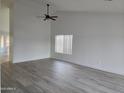 Bright living room with wood-look floors, a high ceiling and a ceiling fan at 4534 E Villa Maria Dr, Phoenix, AZ 85032