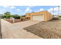 View of the home's front exterior and driveway, leading to the garage at 4802 W Hayward Ave, Glendale, AZ 85301