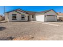 Inviting single-story home with a clean exterior, offering an attached garage and landscaped front yard for charm at 5499 E Red Bird Ln, San Tan Valley, AZ 85140