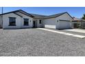 Charming one-story home with a gray gravel yard, concrete walkway and driveway, and a two car garage at 5499 E Red Bird Ln, San Tan Valley, AZ 85140