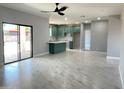 Bright, open-concept living area with light grey tile floors flows into the kitchen at 5499 E Red Bird Ln, San Tan Valley, AZ 85140