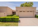 Charming single-story home with a two-car garage, desert landscaping, and tile roof at 8171 E Del Caverna Dr, Scottsdale, AZ 85258