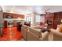 Open-concept living area with hardwood floors, fireplace, and a spacious kitchen at 8171 E Del Caverna Dr, Scottsdale, AZ 85258
