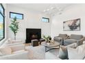 Sun-filled living room with modern fireplace, neutral color palette, and comfortable seating for entertaining guests at 8196 E Sunnyside Dr, Scottsdale, AZ 85260