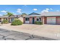 Charming single-story home with brick facade, a green door, and well-maintained landscaping at 9639 W Cinnabar Ave # A, Peoria, AZ 85345