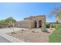 Two-story home showcases desert landscaping and arched entryway at 10448 E Conieson Rd, Scottsdale, AZ 85255