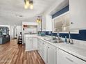 Clean kitchen featuring stainless steel sink, white cabinetry, modern countertops, and ample natural light at 120 N Val Vista Dr # 178, Mesa, AZ 85213