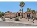 Stunning single-story home with desert landscaping, palm trees, and a convenient three-car garage at 12183 E Mercer Ln, Scottsdale, AZ 85259