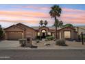 Charming desert home featuring mature palm trees, desert landscaping, three car garage and a welcoming front entry at 12183 E Mercer Ln, Scottsdale, AZ 85259