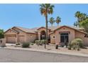 Beautiful home with desert landscaping, palm trees, and a charming entryway at 12183 E Mercer Ln, Scottsdale, AZ 85259