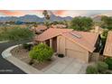 Aerial view of a well-maintained single-story home with desert landscaping and mountain views in the background at 13361 N 99Th Pl, Scottsdale, AZ 85260