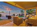 Inviting backyard with covered patio, outdoor kitchen, seating areas and a fire pit with mountain views at 16105 N 183Rd Dr, Surprise, AZ 85388