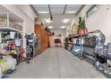 Spacious garage with epoxy flooring, built-in shelving, and ample storage space at 16105 N 183Rd Dr, Surprise, AZ 85388