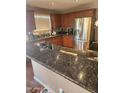 This kitchen has granite counters, stainless appliances, and wood cabinets at 16805 S 29Th Pl, Phoenix, AZ 85048